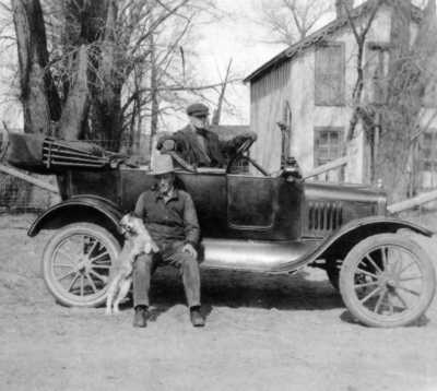 Mills bought his first car in 1919; Bailey sits on the running board with Tootie. He bought the Model T Ford from Ollie Holt for $20 and some mining stock Mills had in a trunk.
