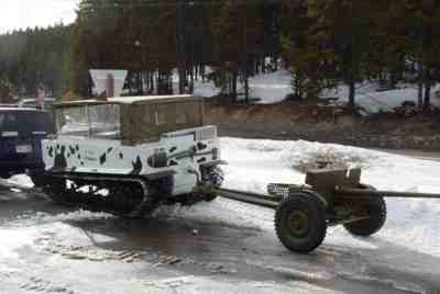 A winter camouflage Weasel snow tractor owned by Russ Morgan of Loveland pulls an anti-tank gun