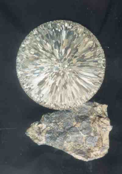 Sintered six-inch disk of pure molybdenum and a piece of Climax molybdenite ore.