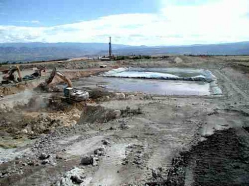 Well pad, evaporation pond and heavy equipment south of Silt, Colo.