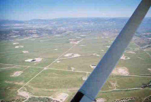 Landscape south of Silt, pockmarked with gas wells, pads, pits, and roads.