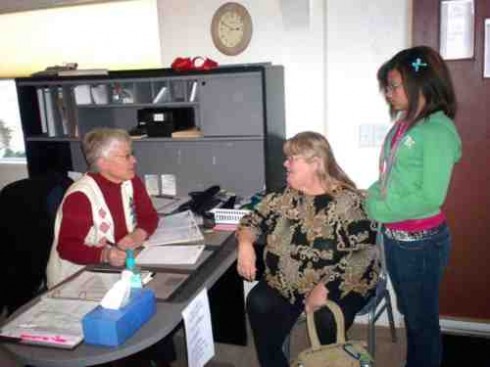 Marilyn Bouldin checks in Berry Bergstrom and Destiny Meseke at the Chaffee People's Clinic.