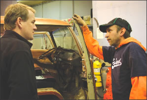 Evolve-it owner Pete Hansen, right, speaks with Colorado’s junior U.S. Senator, Michael Bennet, during a visit to Hansen’s shop in April 2008. Bennet is a proponent of conversion technology.