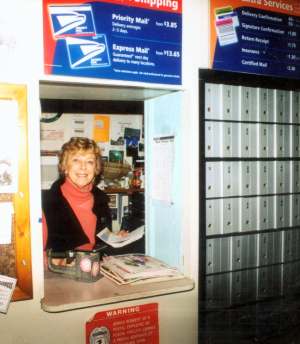 June Hervert at postal counter