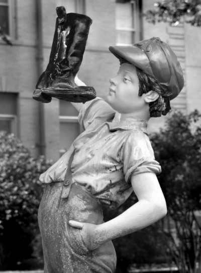 Statue of boy with boot, photo by Mike Russo