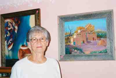 June McDaniel next to one of her paintings.