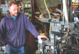 Owner Dean Coombs shows off one of the antiquated Linotype machines used at the Saguache Crescent.