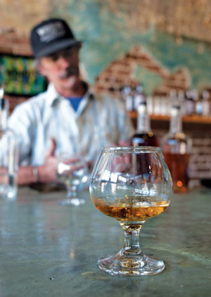 PT Wood serves a glass of Tenderfoot Whiskey in his new distillery in Salida. Photo by Beth Johnston