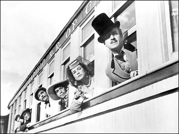 A portion of the Academy Award-winning Best Picture Around the World in 80 Days was filmed around Durango in 1955. Passenger cars usually used on the tourist train between Durango and Silverton were featured in a sequence depicting adventures during a trip across the American West. The film starred David Niven and Shirley MacLaine, who are seen here during an unexpected delay in the journey. Michael Todd Company photo.