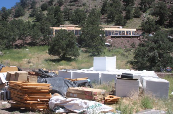 Materials stacked in front of the earthship under construction. Photo by Mike Rosso.