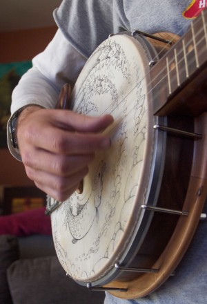 One of Kurt’s authentic goatskin banjo heads is embellished with hand-drawn art inspired by his adventures in the Colorado wilderness. Kurt says the goatskin is sensitive to temperature changes and requires more frequent tuning. photo by Ericka Kastner