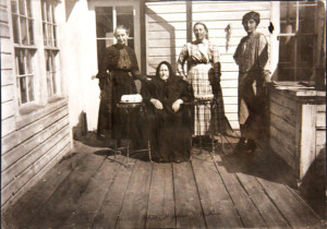 Mrs. Francis E. “Frank” Hayden is pictured seated between two cakes on what might have been her birthday. Her daughter Nellie Hayden Weir is behind her wearing plaid. The photo is probably from the early 1920s, courtesy of CMC.