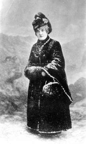 Studio portrait of Elizabeth Bonduel McCourt “Baby Doe” Tabor, wife of millionaire Horace Tabor; she wears a fur coat and hat, and is dusted with fake snow, circa 1885 - 1895. Courtesy of the Denver Public Library.