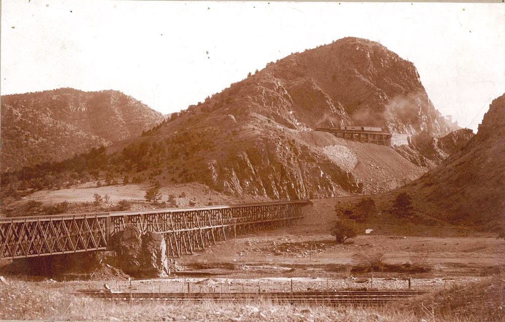 A view of the Texas Creek bridge and a D&R.G.R.R. passenger train climbing up towards Inspiration Point for the trip to Westcliffe, circa 1890s. Courtesy of  the Denver Public Library.