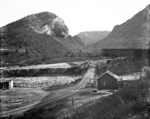 A view of the Denver and Rio Grande Western Railroad trestles over Texas Creek also shows a wooden bridge and sheds, circa 1925. Courtesy of the Denver Public Library.