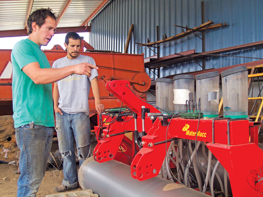 Ring-a-Ding Farm owners, Adam and Noah Ring, explain how the global positioning system works on their high-density spreader. Adam says purchasing the spreader and other automated and mechanized equipment allows them to finally take weekends off from the farm. Insert: Packaging for the farm’s baby beet greens. Photos by Ericka Kastner