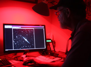 At right, Bradburn examines a computer image of a star system inside his observatory taken with a 17” telescope. Photo by Mike Rosso.